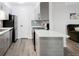 Modern kitchen with stainless steel appliances, gray cabinets, breakfast bar, and adjacent living space at 2800 Kalmia Ave # C101, Boulder, CO 80301