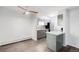 Well-lit living room with hardwood floors, ceiling fan, open kitchen, and clean, minimalist design at 2800 Kalmia Ave # C101, Boulder, CO 80301
