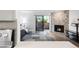 Living room featuring a modern stone fireplace, hardwood floors, a sliding glass door to the outside, and an open kitchen at 2800 Kalmia Ave # C101, Boulder, CO 80301