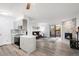 Open-concept living and kitchen space featuring hardwood floors, stone fireplace, and modern gray cabinetry at 2800 Kalmia Ave # C101, Boulder, CO 80301