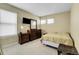 Bedroom with neutral walls, plush carpet, and natural light with a dresser and TV at 3575 S Waco St, Aurora, CO 80013
