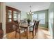 Bright dining area with hardwood floors, a wooden table with seating, and a classic chandelier at 3575 S Waco St, Aurora, CO 80013