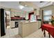 Open kitchen features sleek appliances, tile floors and access to dining area at 3575 S Waco St, Aurora, CO 80013