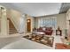 Open-concept living room featuring a fireplace, cozy seating, stairs to the upper level, and an entry door at 3575 S Waco St, Aurora, CO 80013