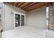 Covered back patio with sliding glass doors offers a private space for outdoor relaxation at 7121 W Asbury Pl, Lakewood, CO 80227