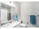 Modern bathroom with white vanity, sleek fixtures, and glass-enclosed shower at 7121 W Asbury Pl, Lakewood, CO 80227