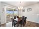 Dining area featuring a wood table, chandelier, and sliding glass doors leading to a deck at 7121 W Asbury Pl, Lakewood, CO 80227