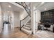 Open entryway featuring hardwood floors, staircase with wrought iron railings, and an office area at 7121 W Asbury Pl, Lakewood, CO 80227