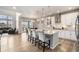 Bright kitchen with white cabinets, stainless appliances, bar seating, and access to a deck at 7121 W Asbury Pl, Lakewood, CO 80227