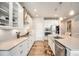 Modern kitchen with stainless steel appliances, white cabinets, and sleek countertops with backsplash at 7121 W Asbury Pl, Lakewood, CO 80227