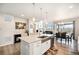Modern open concept kitchen with white countertops, stainless steel appliances, and bright dining area at 7121 W Asbury Pl, Lakewood, CO 80227