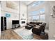 Spacious living room with large windows, a modern fireplace, and comfortable seating at 7121 W Asbury Pl, Lakewood, CO 80227