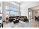 Bright living room with high ceilings, large windows, and a comfortable sectional sofa at 7121 W Asbury Pl, Lakewood, CO 80227