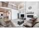 Inviting living room with a cozy fireplace, soaring ceilings, and a comfortable sectional sofa at 7121 W Asbury Pl, Lakewood, CO 80227