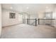 Bright loft features a railing with decorative iron spindles, neutral paint, and multiple windows at 7121 W Asbury Pl, Lakewood, CO 80227