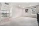 Spacious loft area with neutral paint, carpet, a window, and decorative iron railing at 7121 W Asbury Pl, Lakewood, CO 80227