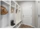 Convenient mudroom with built-in storage cubbies, bench, and coat hooks near entryway at 7121 W Asbury Pl, Lakewood, CO 80227