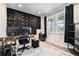 Modern office space with a textured accent wall, two windows, and sleek furniture at 7121 W Asbury Pl, Lakewood, CO 80227