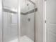 Modern shower with gray tiles and glass door at 7121 W Asbury Pl, Lakewood, CO 80227