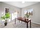 Bright home office featuring natural light, neutral paint, wood desk, and striped area rug at 12427 W Arkansas Ave, Lakewood, CO 80228