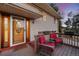 Inviting front porch featuring two red chairs, perfect for relaxing outdoors at 12427 W Arkansas Ave, Lakewood, CO 80228