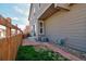 Backyard area featuring grass, brick pavers, and a wooden fence at 21944 E Quincy Cir, Aurora, CO 80015