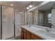 Bright bathroom featuring a double sink vanity and a glass-enclosed shower at 21944 E Quincy Cir, Aurora, CO 80015