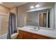 Bathroom featuring a large mirror, wood cabinet, and a shower with a curtain at 21944 E Quincy Cir, Aurora, CO 80015