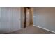 Neutral bedroom featuring an open doorway, with neutral colored walls and carpet at 21944 E Quincy Cir, Aurora, CO 80015