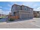 Two-story home featuring a two-car garage, fenced yard, and nearby street parking at 21944 E Quincy Cir, Aurora, CO 80015