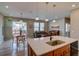 Open-concept space featuring a kitchen island, dining area, and living room at 21944 E Quincy Cir, Aurora, CO 80015