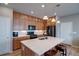 Modern kitchen featuring stainless steel appliances, island, and wooden cabinets at 21944 E Quincy Cir, Aurora, CO 80015
