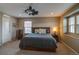 Spacious main bedroom featuring a ceiling fan, natural light, and neutral colors at 21944 E Quincy Cir, Aurora, CO 80015