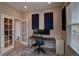 Bright office with a desk, and French doors at 21944 E Quincy Cir, Aurora, CO 80015