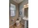 Cozy powder room featuring a pedestal sink, and a toilet at 21944 E Quincy Cir, Aurora, CO 80015