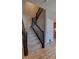 Staircase featuring carpeted steps and a dark wooden railing at 21944 E Quincy Cir, Aurora, CO 80015