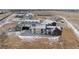 Expansive aerial view of modern home featuring a large lot, metal roofing, and snow dusted ground at 28450 E 159Th Ave, Brighton, CO 80603