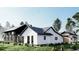 Beautifully designed house rendering with lush landscaping, dark trim, and a mix of textures and materials at 28450 E 159Th Ave, Brighton, CO 80603