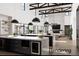 Modern, bright kitchen with large islands, pendant lighting, and an open layout leading to a cozy living area at 28450 E 159Th Ave, Brighton, CO 80603