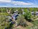 Aerial view of a blue house surrounded by trees, a trampoline, and fenced yards in a residential area at 8680 Apache Plume Dr, Parker, CO 80134