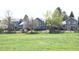 View of home exteriors with large backyards and wooden fences, surrounded by green grass at 8680 Apache Plume Dr, Parker, CO 80134