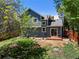 Backyard features a small patio and a fire pit, surrounded by trees and a wooden fence at 8680 Apache Plume Dr, Parker, CO 80134