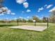 Outdoor basketball court with picnic tables and greenery under a bright blue, partly cloudy sky at 8680 Apache Plume Dr, Parker, CO 80134