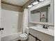 Well-lit bathroom featuring a shower-tub combination, vanity with mirror and a toilet at 8680 Apache Plume Dr, Parker, CO 80134
