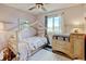 Charming bedroom with playhouse bed, changing station and ample natural light at 8680 Apache Plume Dr, Parker, CO 80134