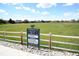 Cottonwood community sign with park rules with grassy area, fences, and neighborhood in background at 8680 Apache Plume Dr, Parker, CO 80134