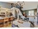 Open-concept dining area boasts a modern chandelier, staircase, and seamless flow into the living room at 8680 Apache Plume Dr, Parker, CO 80134