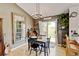 Charming dining area showcases a rustic table, modern chandelier, and seamless flow to the kitchen at 8680 Apache Plume Dr, Parker, CO 80134