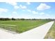 Expansive green space with walking path and wooden fence with a view of the neighborhood at 8680 Apache Plume Dr, Parker, CO 80134