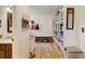 Inviting hallway with hardwood floors, built-in storage, and shelving for pantry items at 8680 Apache Plume Dr, Parker, CO 80134